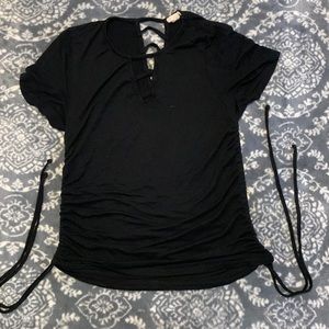 A black shirt with cut outs on front and back